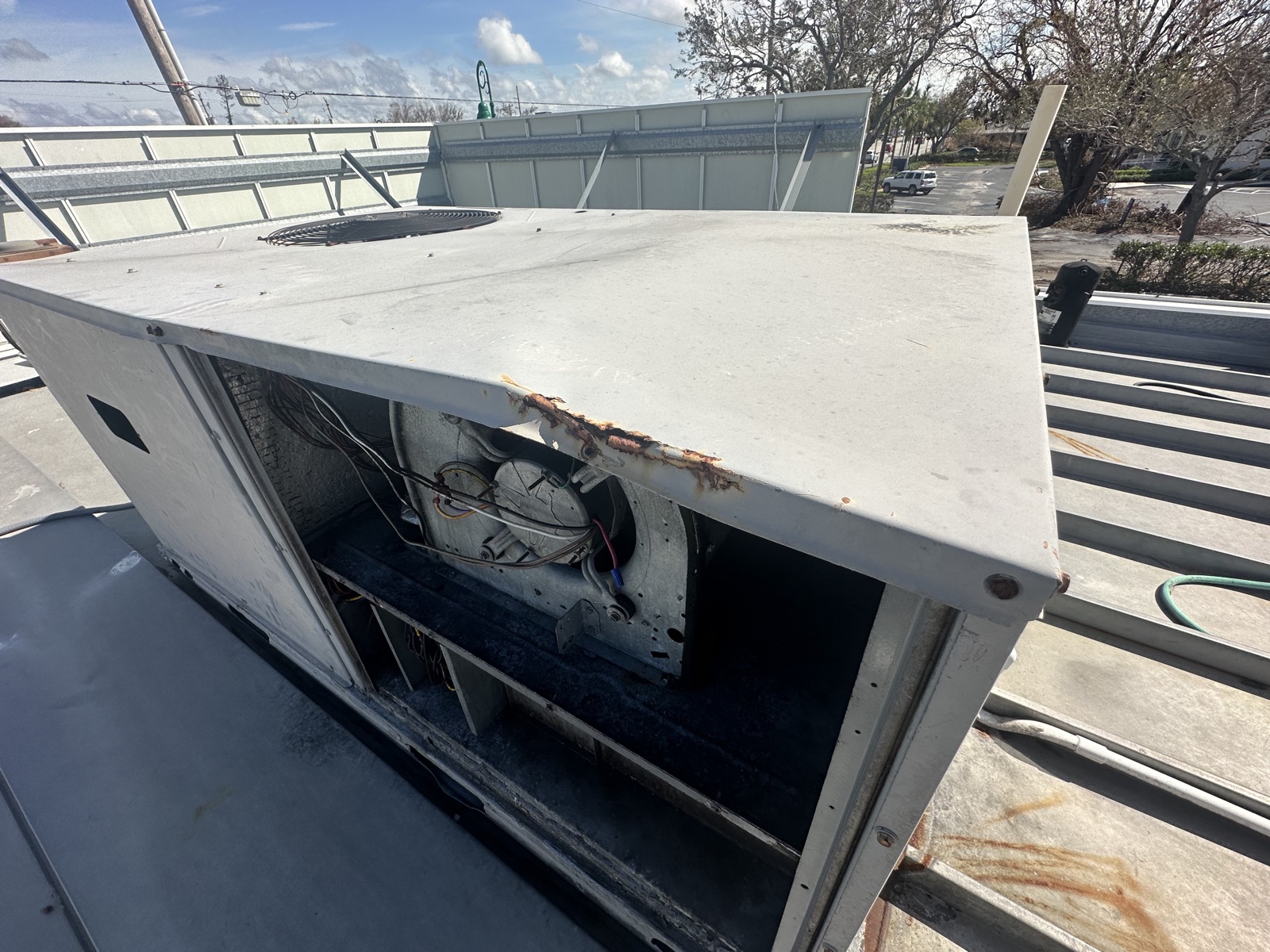 Hurricane-damaged rooftop HVAC unit on a South Florida commercial building — commercial insurance claim — Greenlight Claims